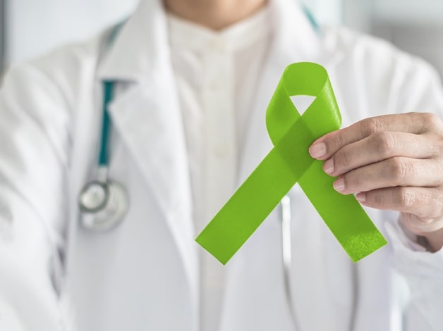 Doctor holding Green ribbon for mental health awareness
